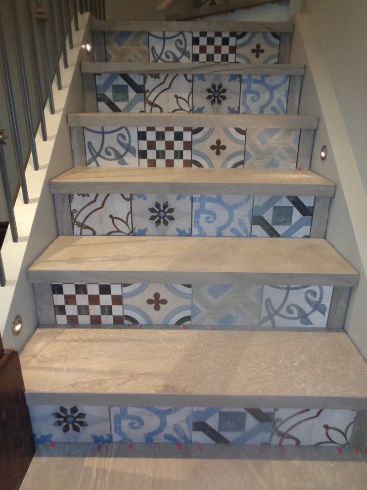 Transitional tile straight staircase photo in Calgary with tile risers