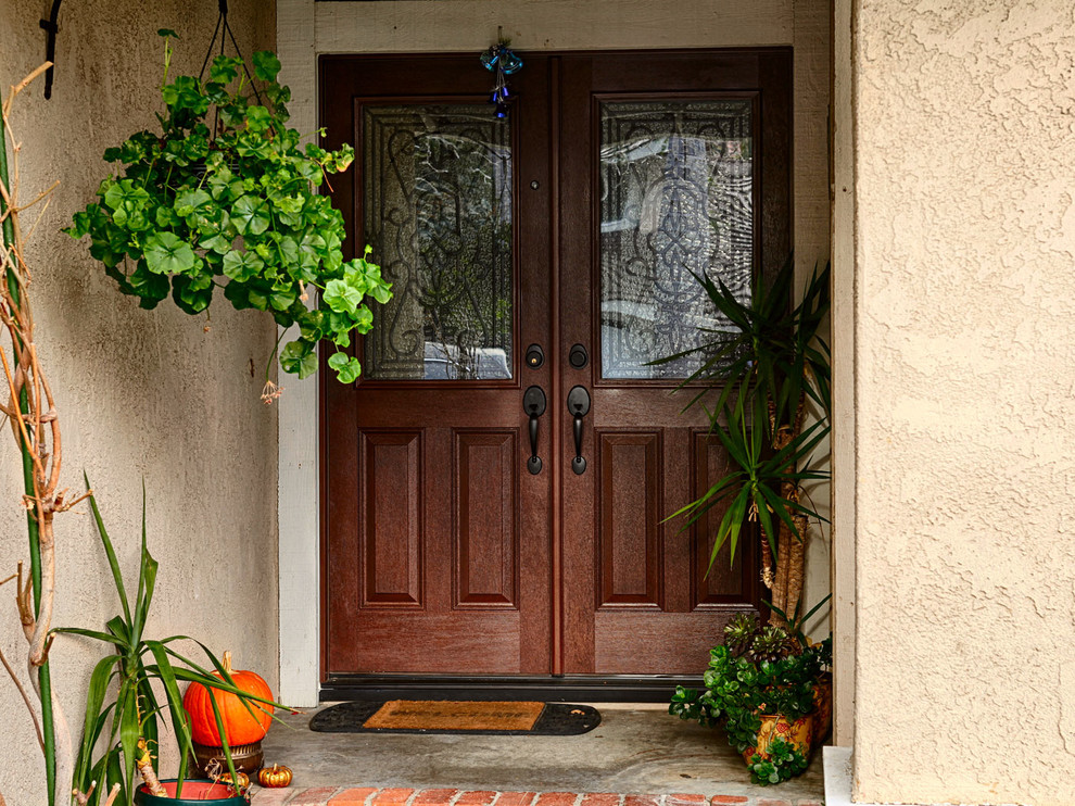 Inspiration for a large rustic front door remodel in Orange County with beige walls and a medium wood front door