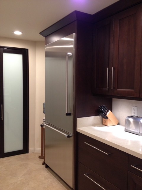 Example of a transitional kitchen design in Los Angeles with white backsplash and stainless steel appliances