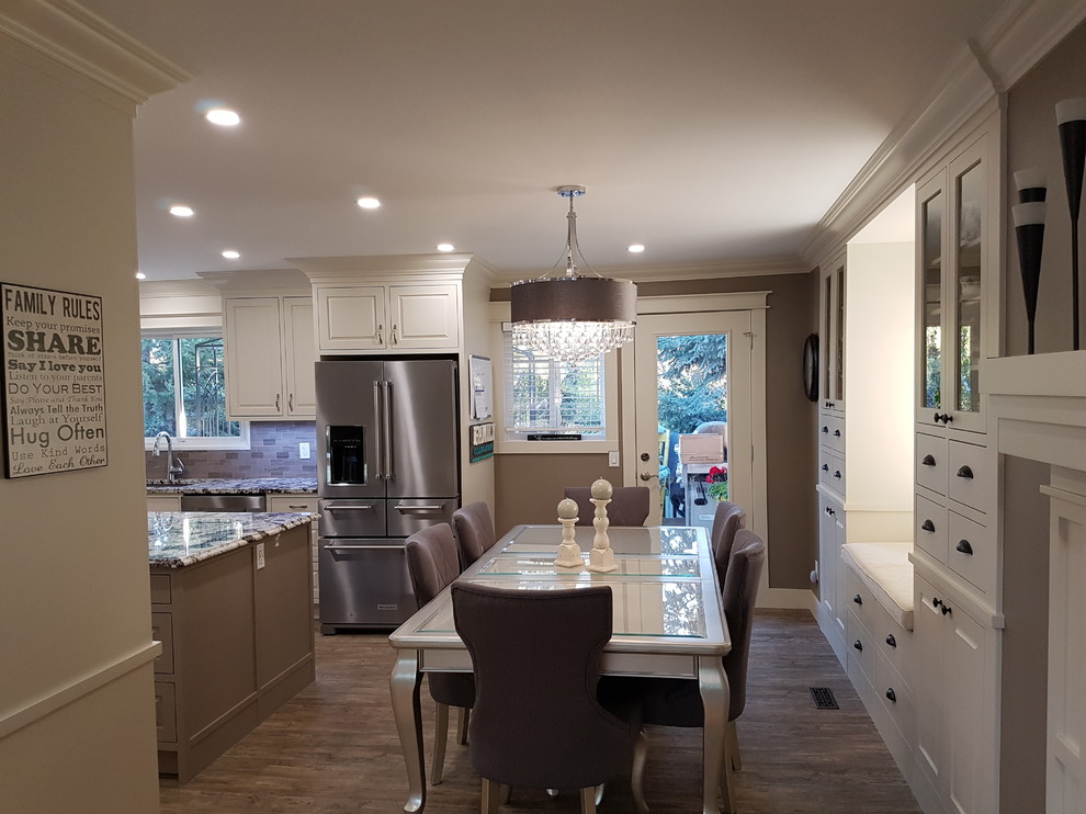 Example of a mid-sized transitional vinyl floor and gray floor kitchen/dining room combo design in Calgary with gray walls, a standard fireplace and a tile fireplace