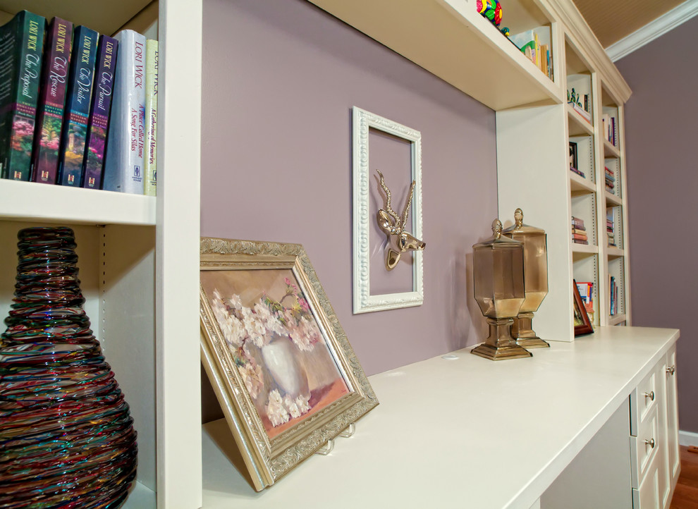 Inspiration for a mid-sized contemporary study room in St Louis with purple walls, dark hardwood floors, a built-in desk and brown floor.