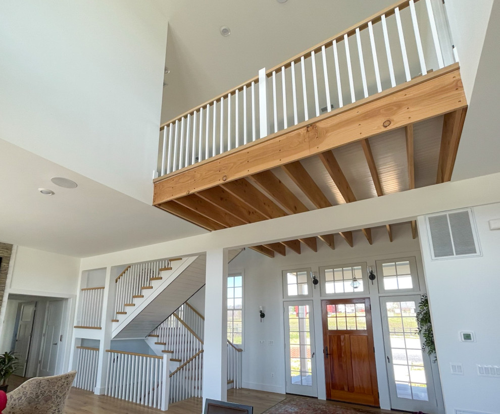 Example of a mid-sized cottage wooden u-shaped wood railing and shiplap wall staircase design in DC Metro with wooden risers