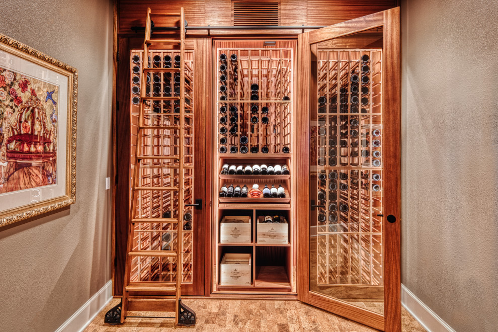 Design ideas for a small arts and crafts wine cellar in Portland with cork floors and storage racks.