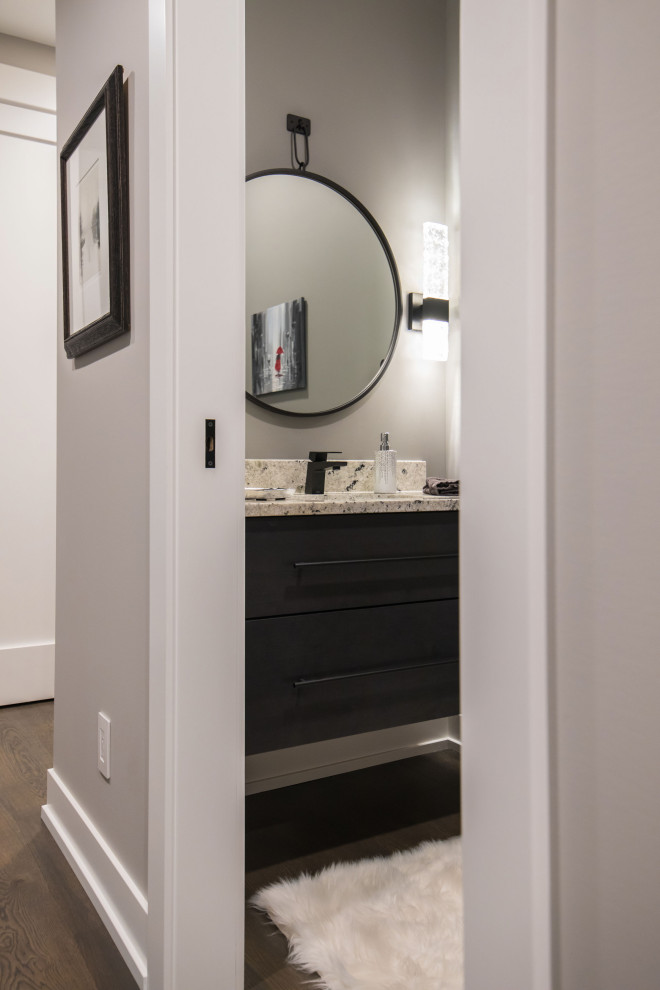 Photo of a contemporary cloakroom in Grand Rapids with flat-panel cabinets, brown cabinets, grey walls, a submerged sink, engineered stone worktops, brown floors, grey worktops, a floating vanity unit and medium hardwood flooring.