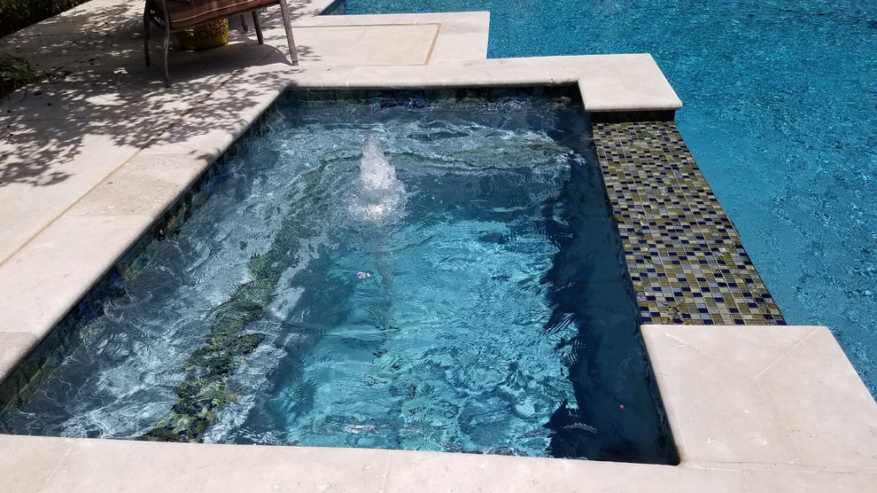Example of a large transitional backyard concrete and custom-shaped lap hot tub design in Dallas