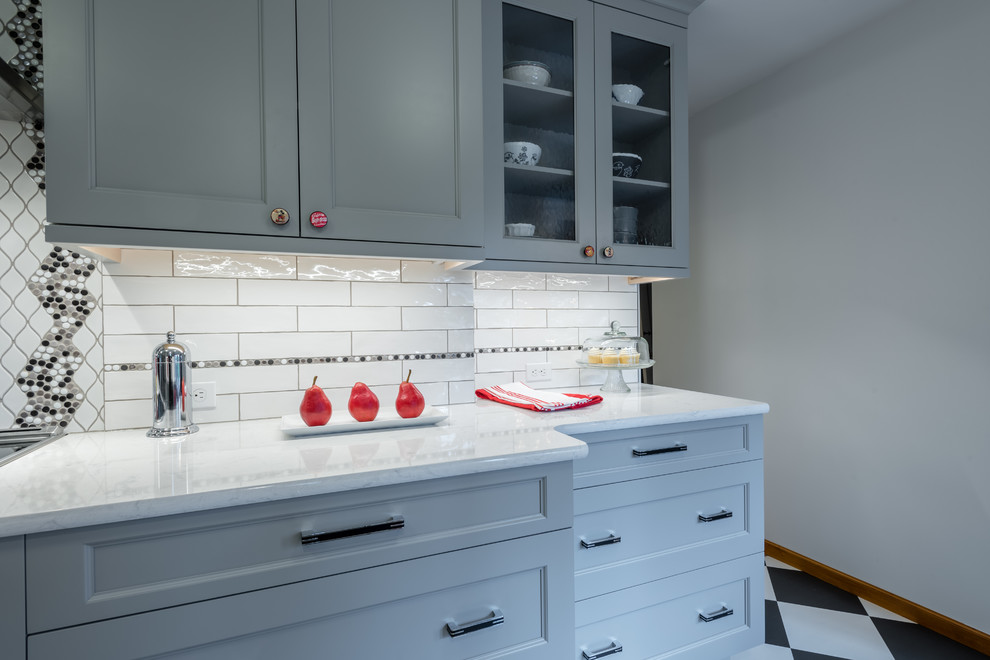 Design ideas for a mid-sized transitional galley eat-in kitchen in Seattle with a farmhouse sink, shaker cabinets, grey cabinets, quartz benchtops, multi-coloured splashback, porcelain splashback, stainless steel appliances, vinyl floors, no island and multi-coloured floor.
