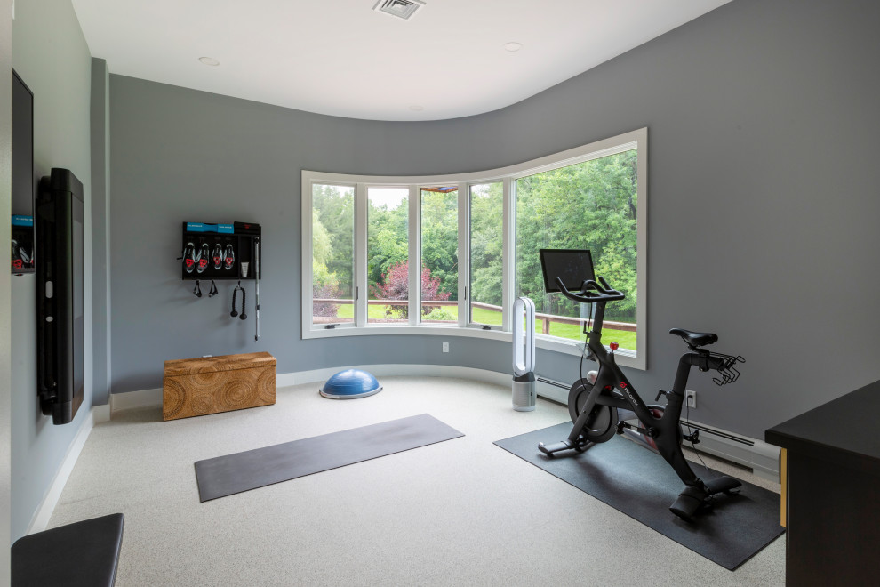 This is an example of a large contemporary home weight room in New York with blue walls, cork floors and white floor.