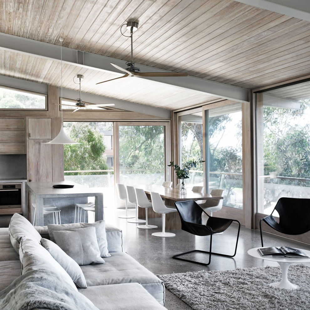 Photo of a contemporary open concept living room in Milan with concrete floors.