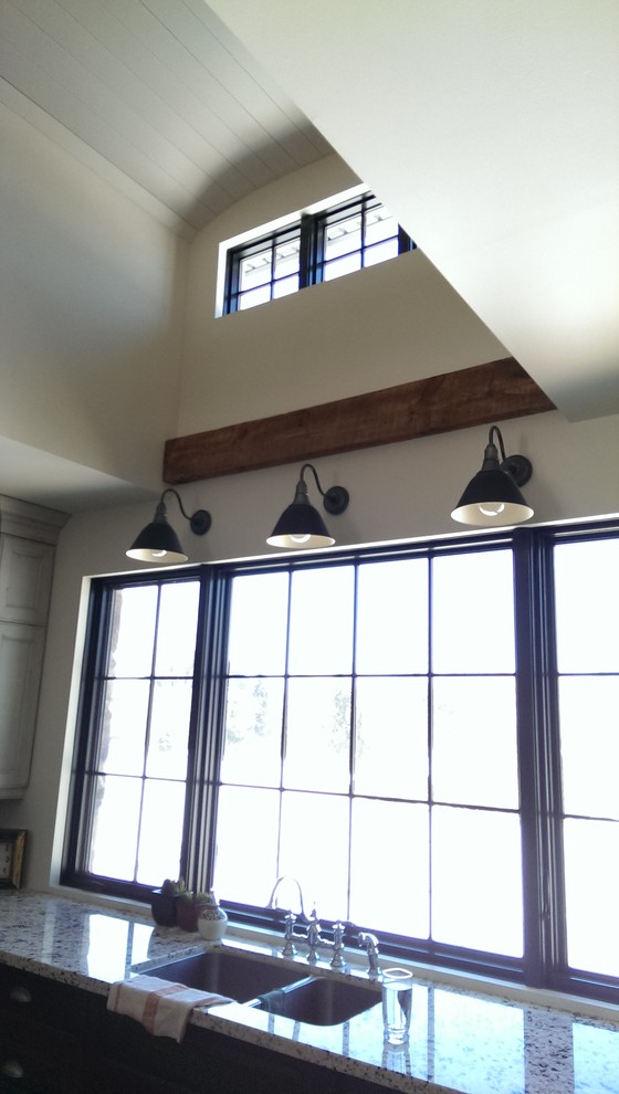 Inspiration for an eclectic l-shaped medium tone wood floor open concept kitchen remodel in Toronto with an undermount sink, recessed-panel cabinets, distressed cabinets, granite countertops and an island