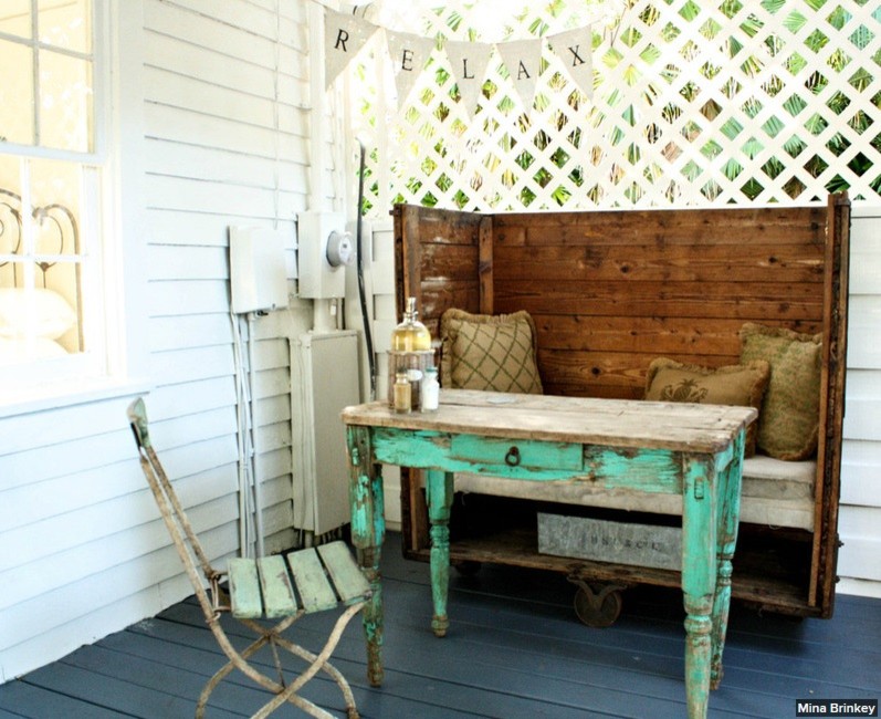 This is an example of a mid-sized beach style back porch design in Tampa with decking and a roof extension.