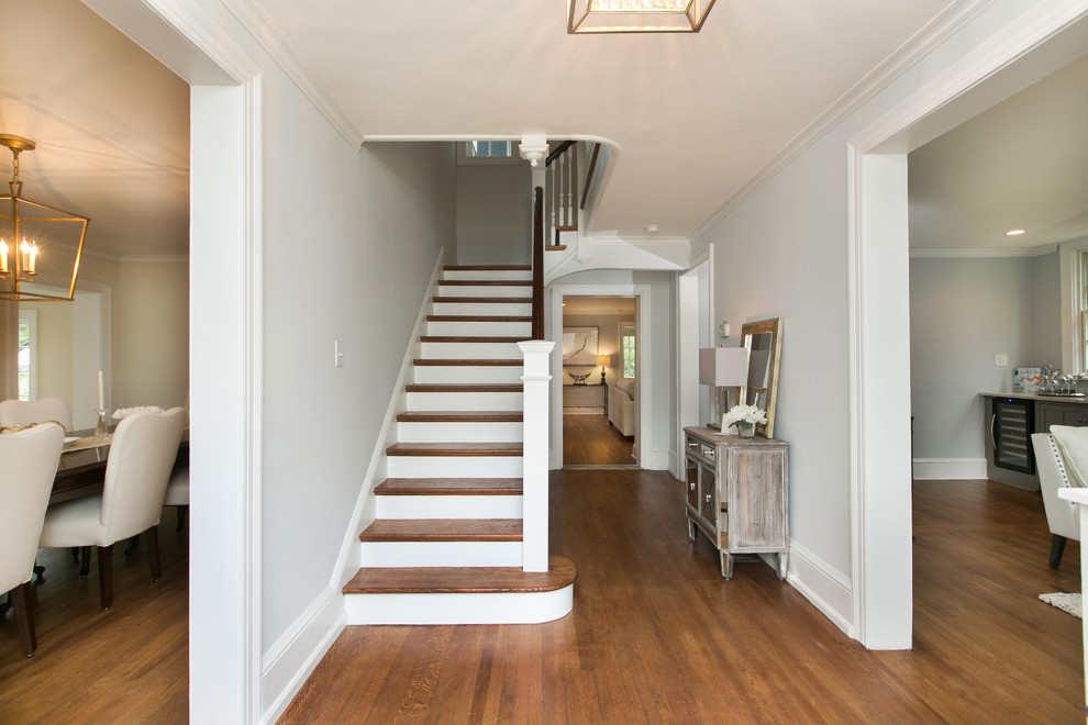 This is an example of a mid-sized traditional foyer in Philadelphia with grey walls, medium hardwood floors and brown floor.