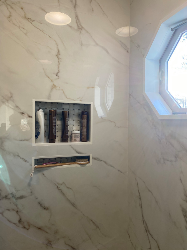 Example of a large master porcelain tile porcelain tile and double-sink bathroom design in Other with flat-panel cabinets, white cabinets, a two-piece toilet, beige walls, an undermount sink, tile countertops and a built-in vanity