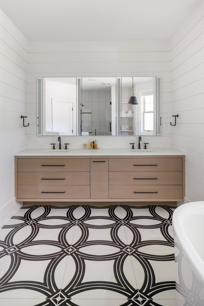 This is an example of a mid-sized country bathroom in Vancouver with a freestanding tub, white tile, wood-look tile, marble benchtops and a double vanity.
