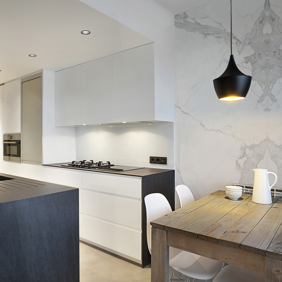 Inspiration for a contemporary eat-in kitchen in Essex with a drop-in sink, flat-panel cabinets, white cabinets, stainless steel appliances, with island and beige floor.