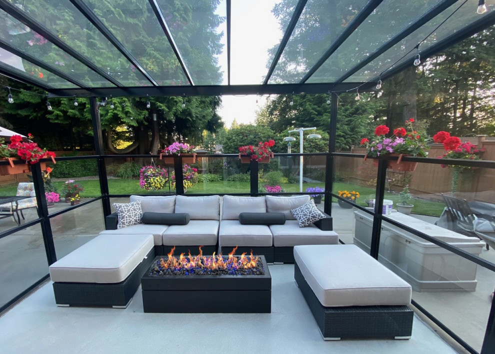 Photo of a contemporary backyard patio in Vancouver with a fire feature and no cover.