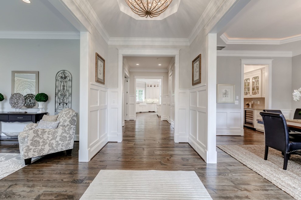Design ideas for a mid-sized transitional entry hall in DC Metro with white walls and plywood floors.