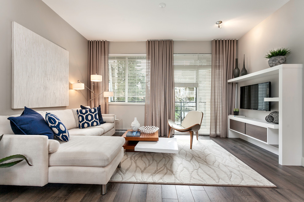 Living room - small contemporary open concept medium tone wood floor living room idea in Vancouver with gray walls, no fireplace and a wall-mounted tv