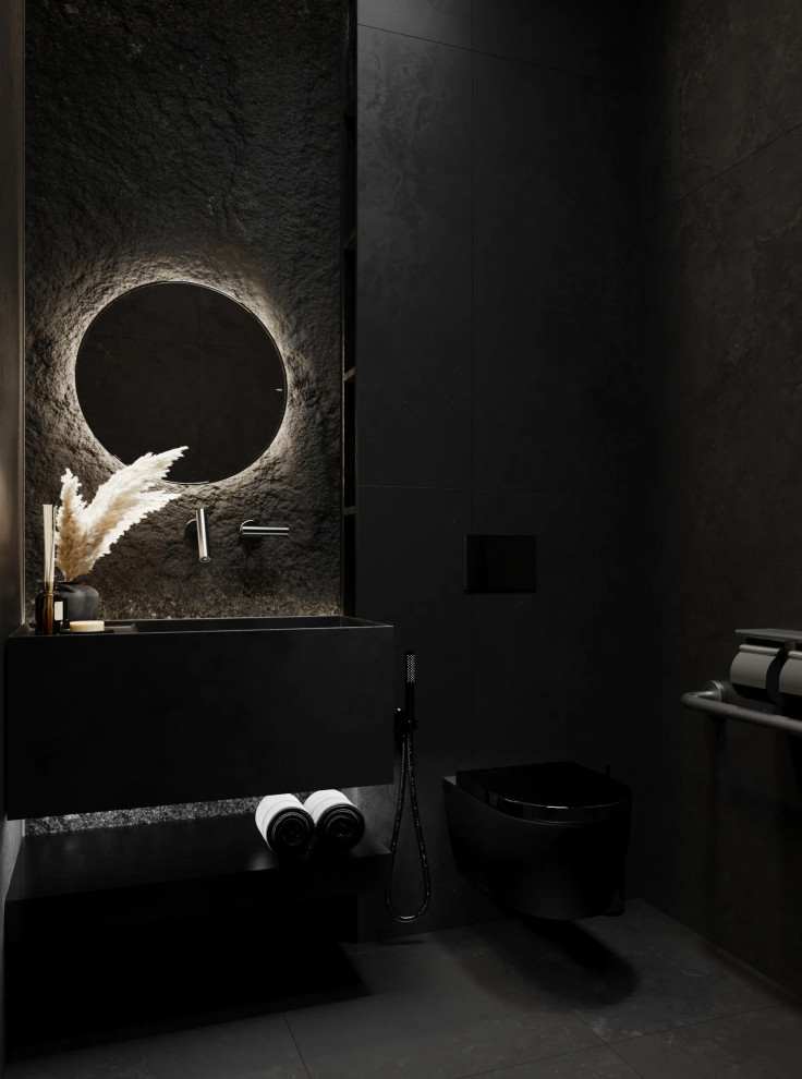 Foto di un piccolo bagno di servizio minimalista con piastrelle nere, pareti nere, pavimento nero e top nero