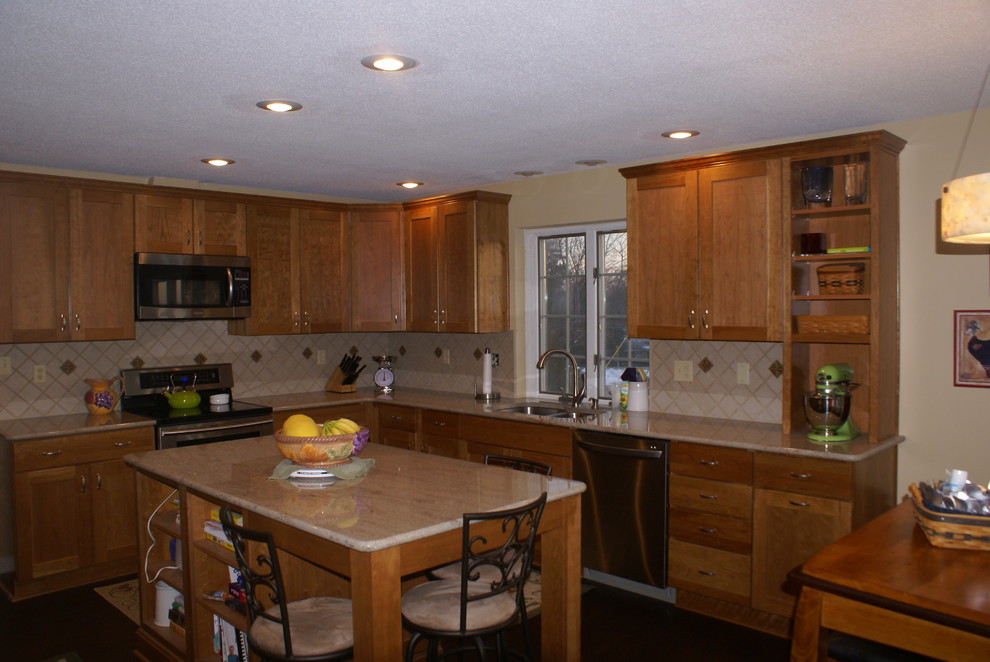Example of a transitional l-shaped eat-in kitchen design in Indianapolis with an undermount sink, recessed-panel cabinets, light wood cabinets, granite countertops and stainless steel appliances