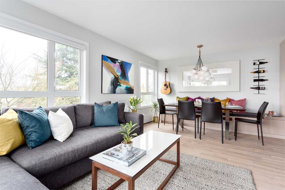 Design ideas for a small transitional open concept living room in Vancouver with grey walls, light hardwood floors and beige floor.