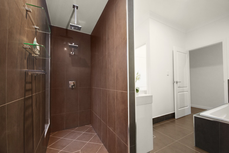 Design ideas for a mid-sized contemporary kids bathroom in Cairns with a drop-in tub, a corner shower, gray tile, ceramic tile and white walls.