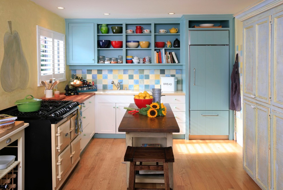 Design ideas for a traditional l-shaped separate kitchen in San Francisco with an undermount sink, recessed-panel cabinets, blue cabinets, wood benchtops, multi-coloured splashback and ceramic splashback.