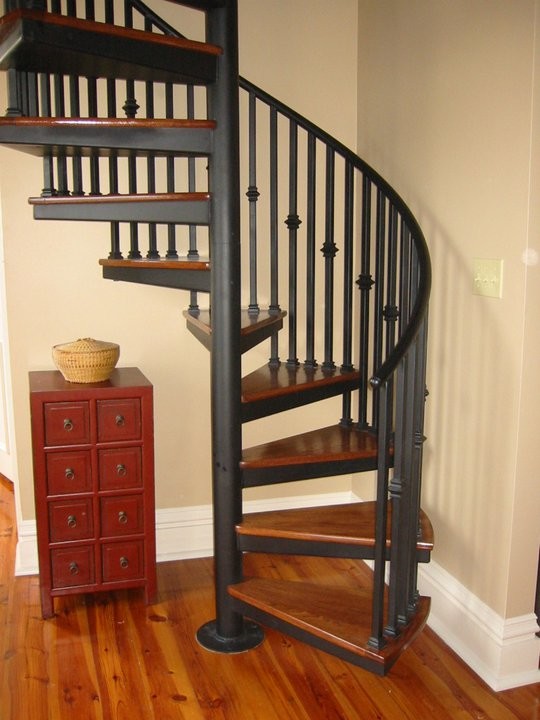 This is an example of a mid-sized contemporary wood spiral staircase in San Diego with open risers.