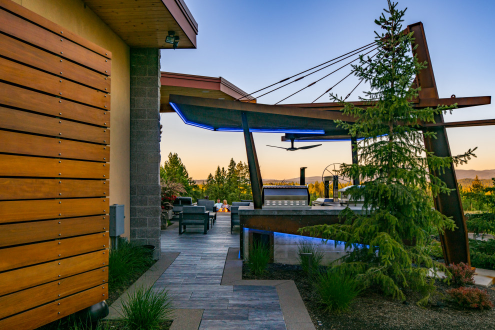 Design ideas for a mid-sized modern backyard garden in Seattle with natural stone pavers.