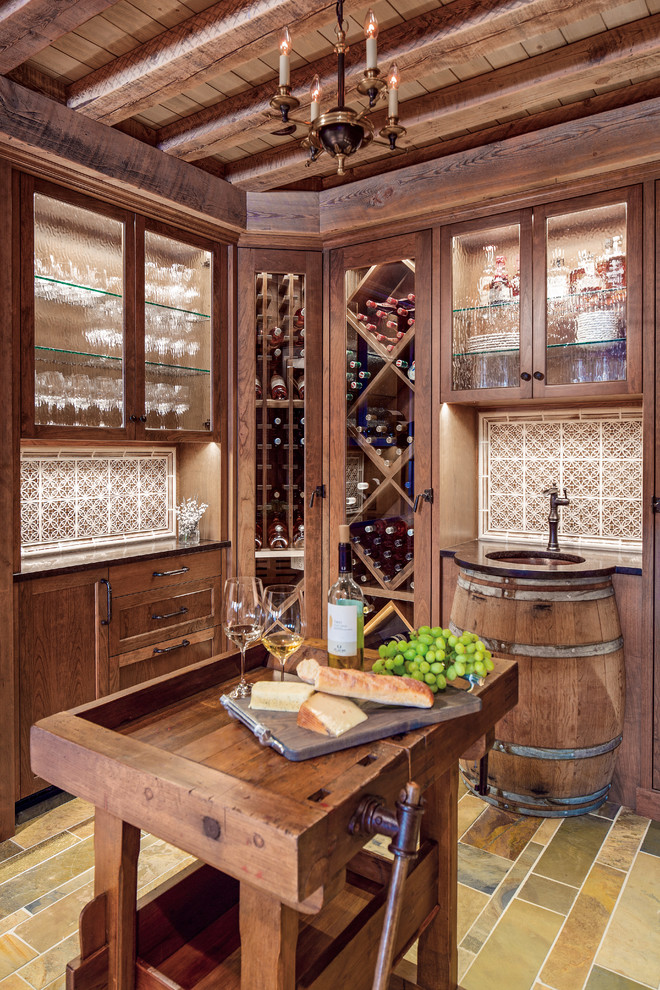 Photo of a large traditional wine cellar in Minneapolis with slate floors and storage racks.