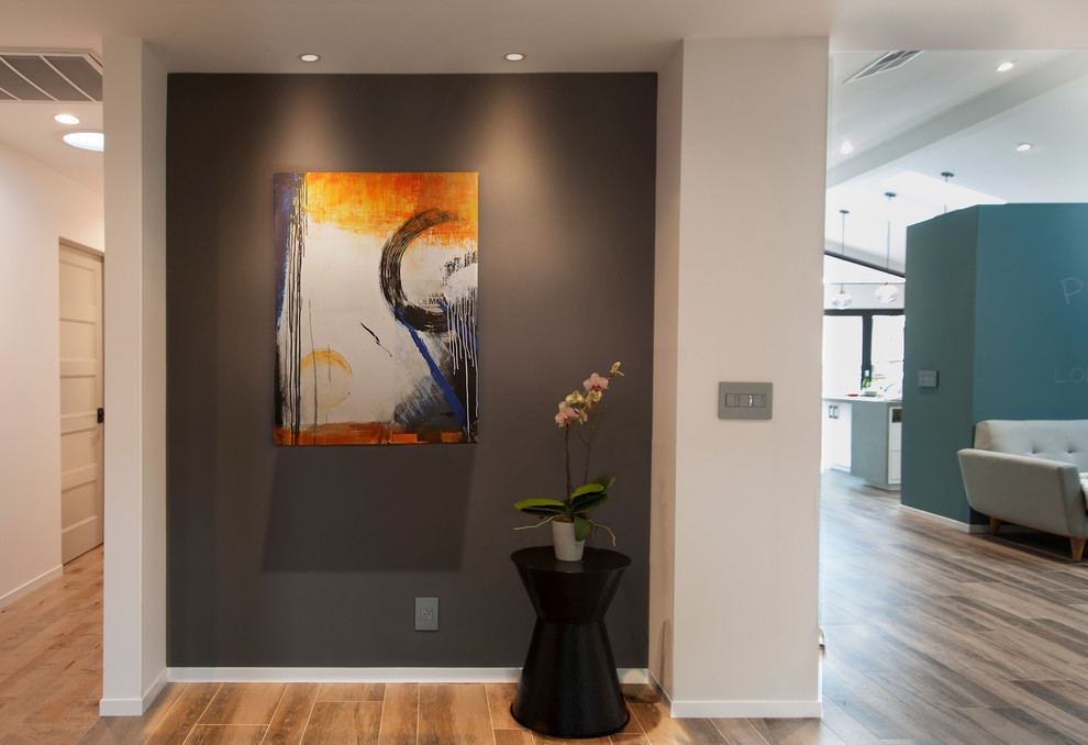 Mid-sized contemporary foyer in San Francisco with grey walls and a dark wood front door.