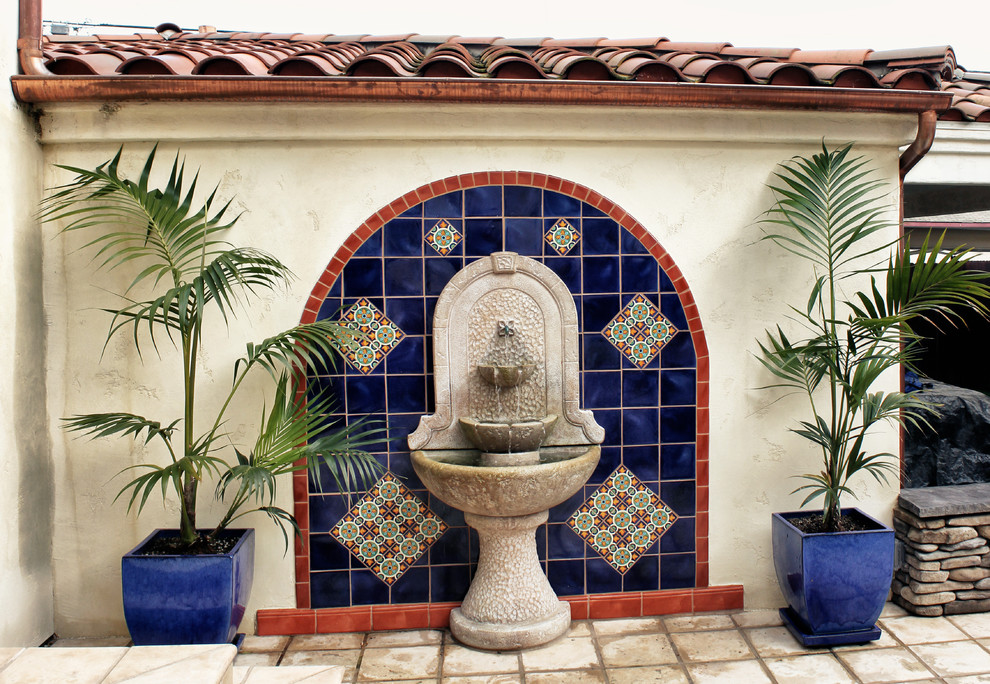 Photo of a mediterranean patio in San Diego with a water feature and no cover.