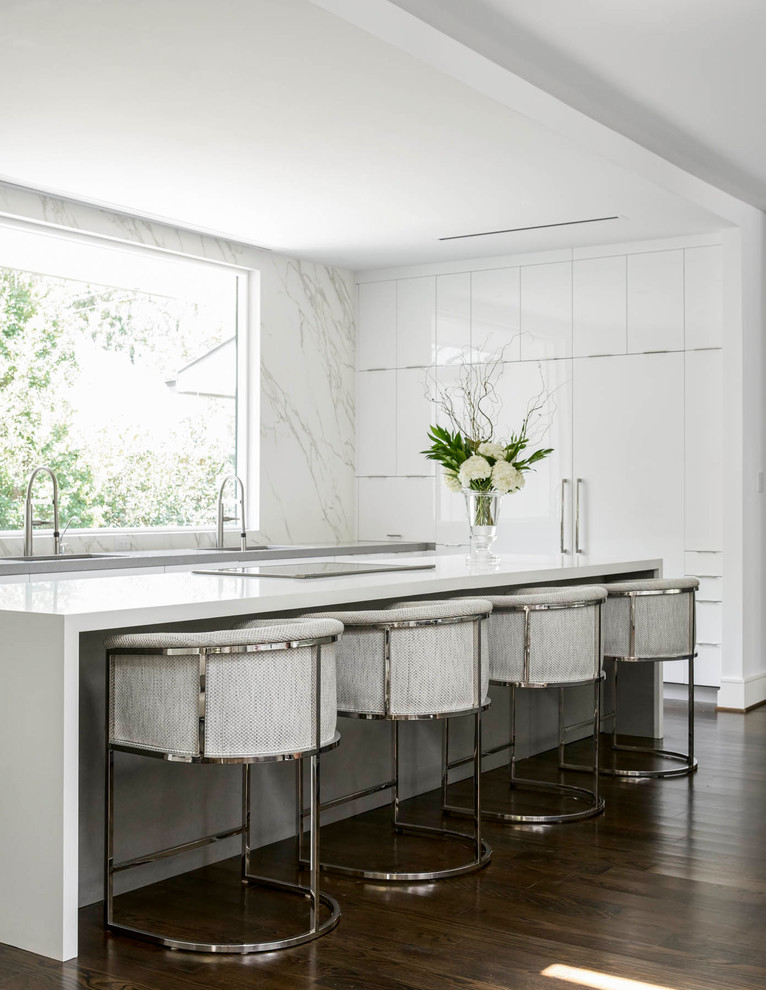 Trendy l-shaped dark wood floor and brown floor kitchen photo in Dallas with an undermount sink, flat-panel cabinets, white cabinets, white backsplash, paneled appliances and an island