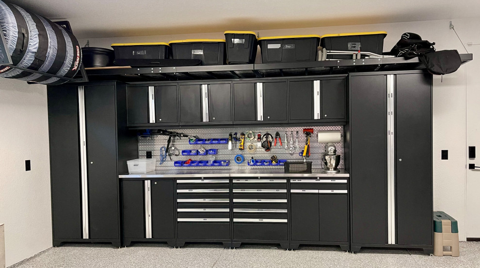 Example of a large minimalist three-car garage design in Denver