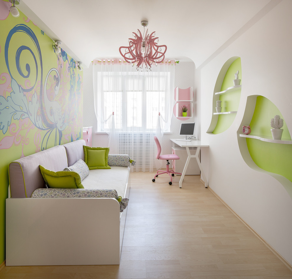 This is an example of a contemporary kids' room for kids 4-10 years old and girls in Other with multi-coloured walls and light hardwood floors.