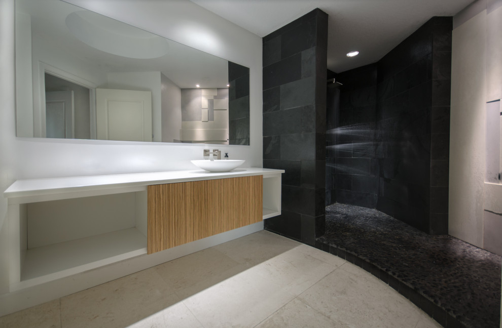 Mid-sized contemporary master bathroom in Tampa with furniture-like cabinets, white cabinets, an open shower, multi-coloured tile, cement tile, a vessel sink, glass benchtops, an open shower and white benchtops.