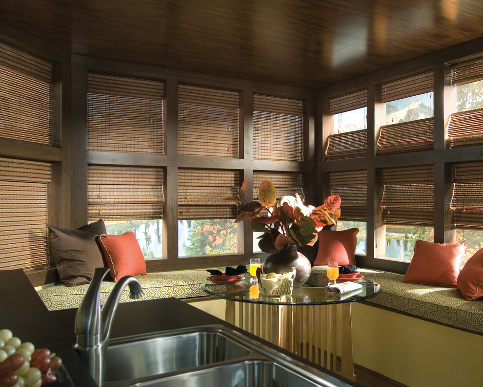 Example of a mid-sized transitional u-shaped open concept kitchen design in Edmonton with a double-bowl sink, solid surface countertops and stainless steel appliances