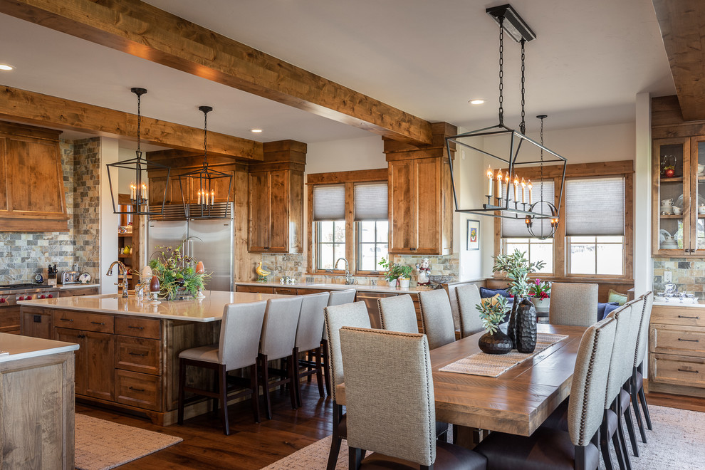 Inspiration for a country eat-in kitchen in Other with recessed-panel cabinets, medium wood cabinets, multi-coloured splashback, stainless steel appliances, dark hardwood floors, with island and beige benchtop.