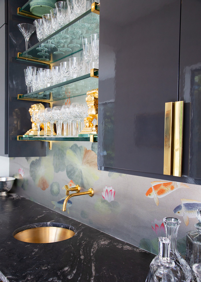 This is an example of a mid-sized eclectic single-wall wet bar in Austin with an undermount sink, flat-panel cabinets, black cabinets, marble benchtops and black benchtop.