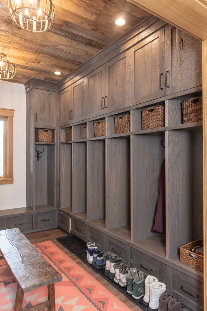Inspiration for a country mudroom in Salt Lake City with white walls and dark hardwood floors.