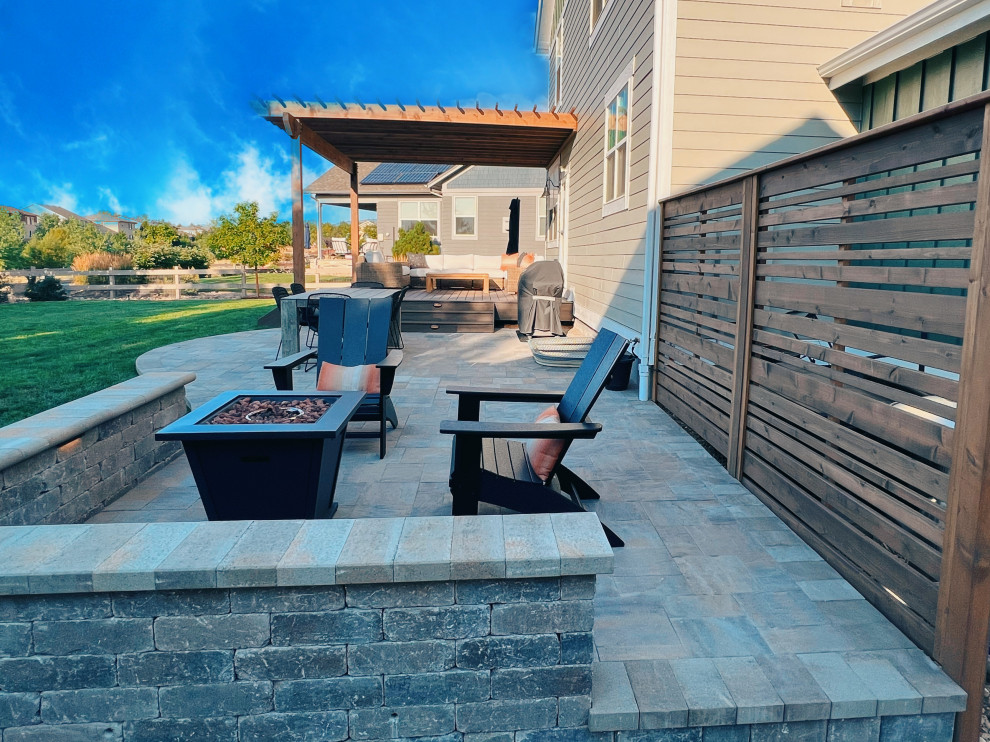 Design ideas for a mid-sized contemporary backyard patio in Denver with a fire feature, decking and a pergola.