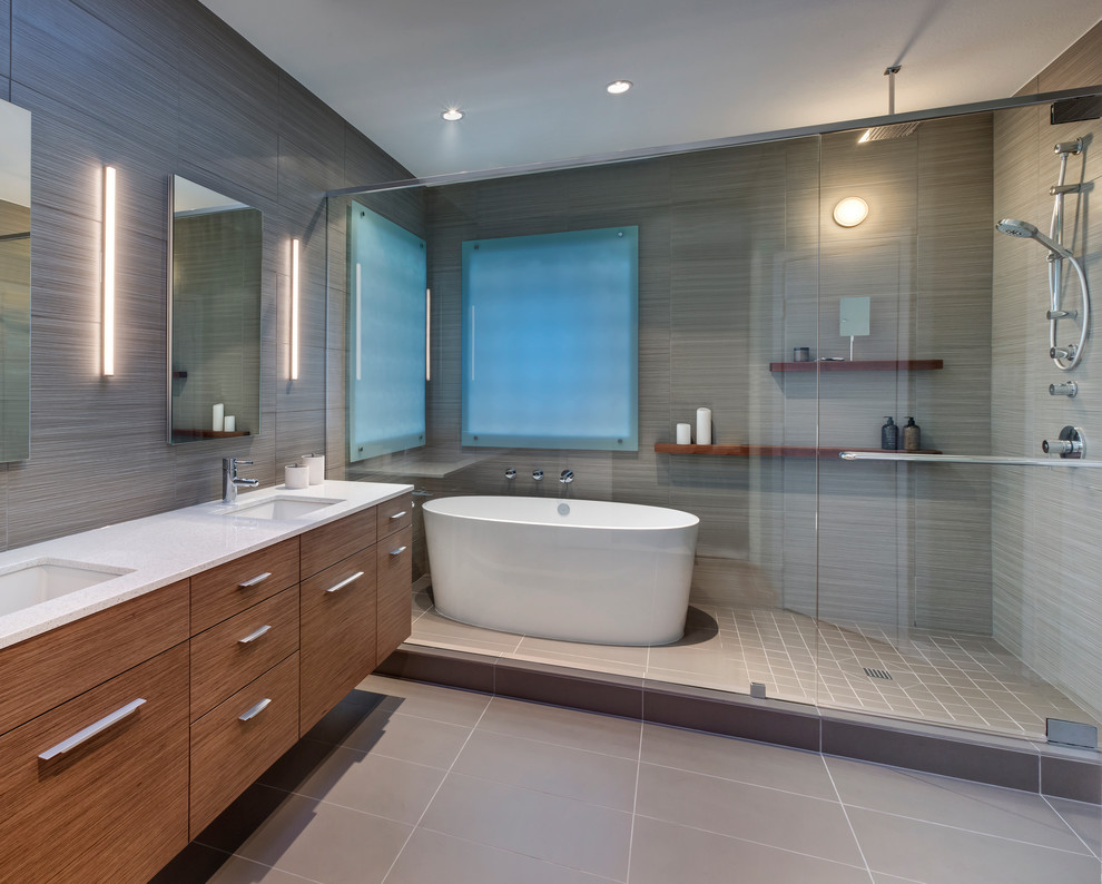 Design ideas for a mid-sized modern master bathroom in Dallas with an undermount sink, furniture-like cabinets, medium wood cabinets, recycled glass benchtops, a freestanding tub, an open shower, beige tile, porcelain tile and porcelain floors.