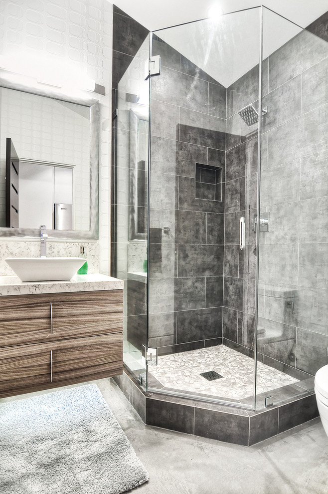 Design ideas for a mid-sized contemporary master bathroom in Orange County with a vessel sink, flat-panel cabinets, medium wood cabinets, a corner shower, gray tile, a corner tub, a one-piece toilet, stone tile, white walls, concrete floors and granite benchtops.
