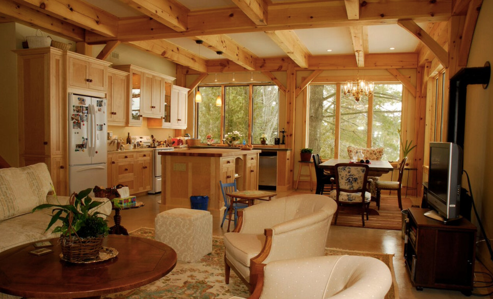 Example of a large mountain style light wood floor open concept kitchen design in Boston with an undermount sink, shaker cabinets, light wood cabinets, wood countertops, stainless steel appliances and an island