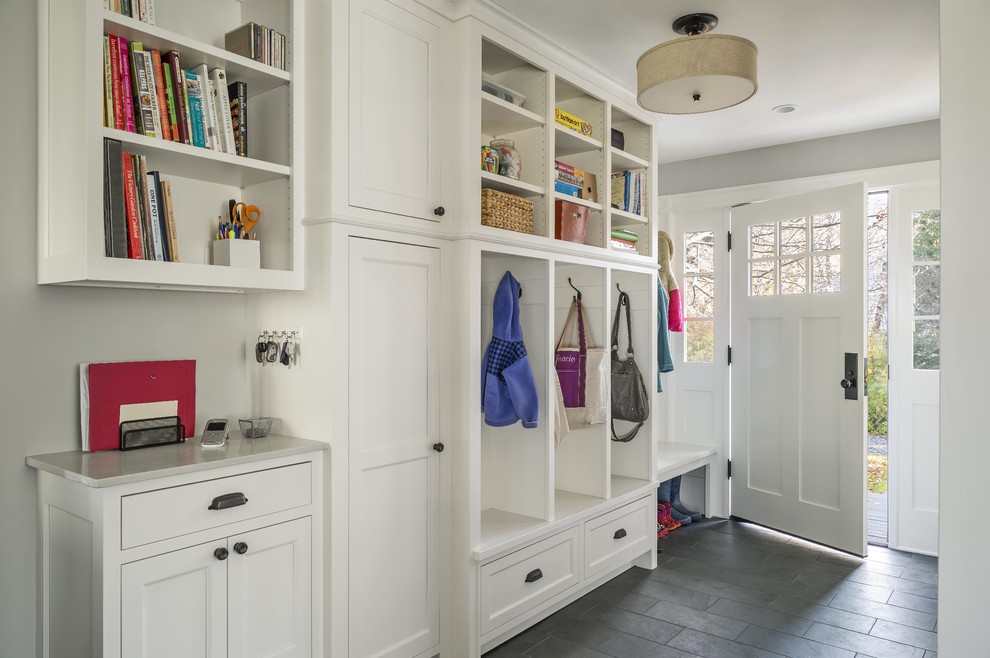 Design ideas for a mid-sized country mudroom in Boston with grey walls, slate floors and a single front door.
