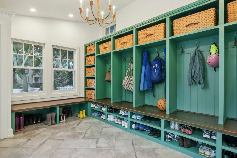 Large transitional limestone floor and gray floor mudroom photo in Milwaukee with white walls and a white front door