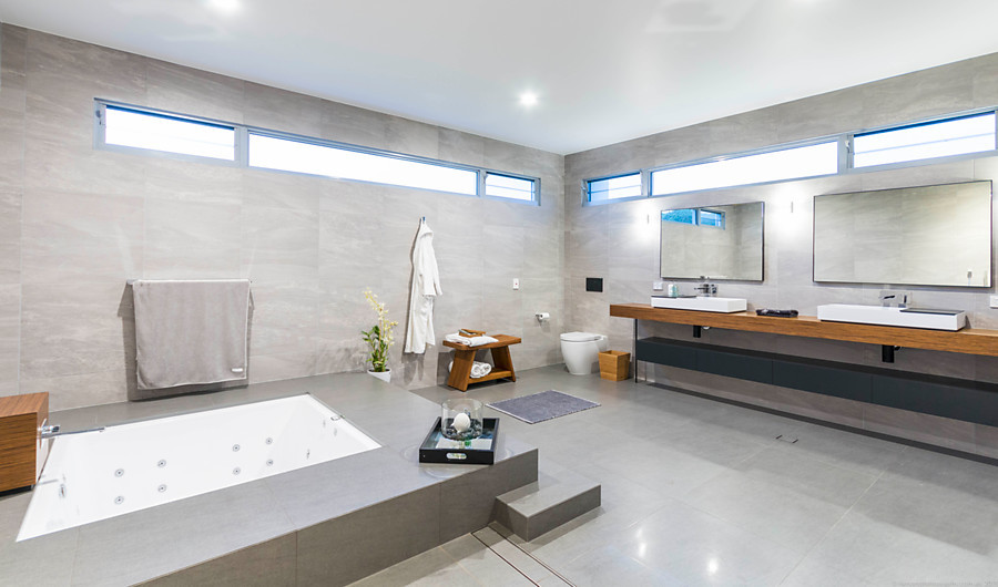 Design ideas for a large contemporary bathroom in Gold Coast - Tweed with an undermount tub, an open shower, a wall-mount toilet, gray tile, porcelain tile, grey walls and porcelain floors.