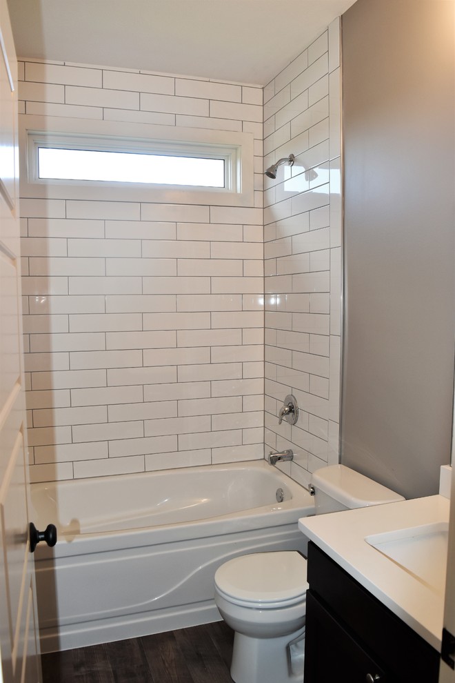 Mid-sized country kids bathroom in Other with raised-panel cabinets, black cabinets, a shower/bathtub combo, grey walls, an undermount sink and a shower curtain.