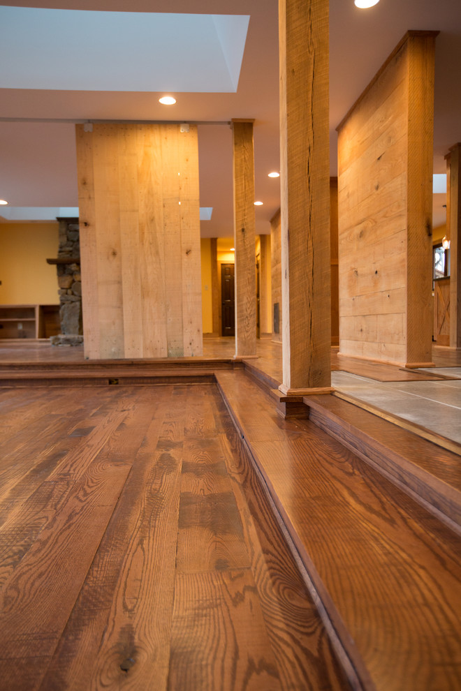 Inspiration for a large rustic dark wood floor hallway remodel with orange walls