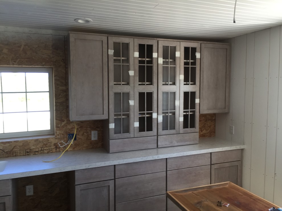Inspiration for a large traditional l-shaped open plan kitchen in Cedar Rapids with an undermount sink, recessed-panel cabinets, grey cabinets, laminate benchtops, black appliances and with island.