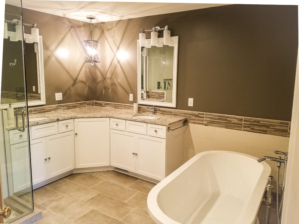 Inspiration for a large transitional master multicolored tile and ceramic tile porcelain tile and gray floor freestanding bathtub remodel with shaker cabinets, white cabinets, a two-piece toilet, gray walls, an undermount sink, granite countertops and a hinged shower door